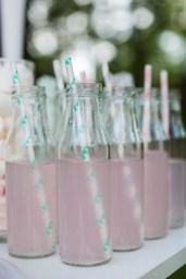 small glass bottles with pink lemonade