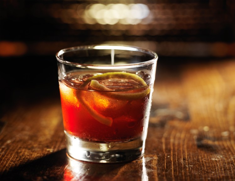 sazerac cocktail on dark wooden background