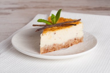 Vanilla cheesecake on a white plate, close up