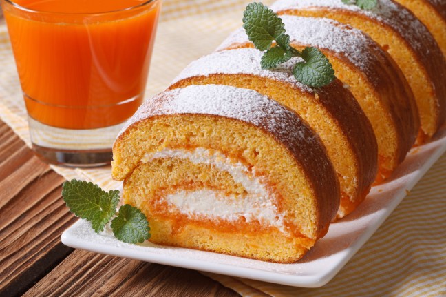 Tasty dessert of pumpkin roll with cream closeup