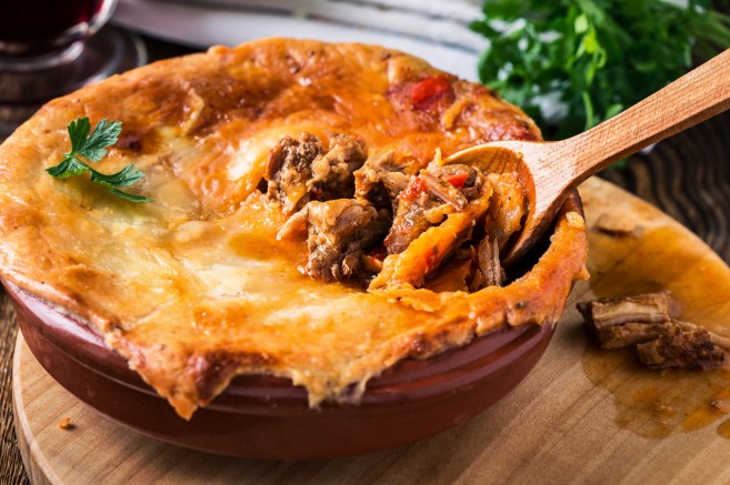 Juicy meat pot pie in a ceramic oven pot